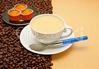 White cup of coffee and coffee beans