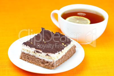 lemon tea and cake on the orange fabric