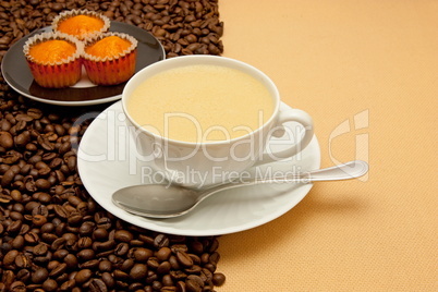 White cup of coffee and coffee beans