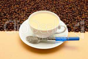 White cup of coffee and coffee beans