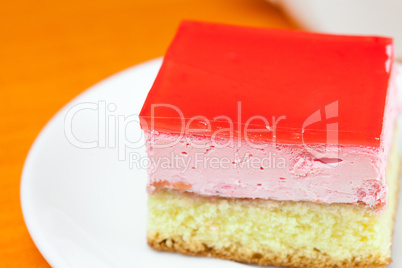 cake at the plate lying on an orange cloth