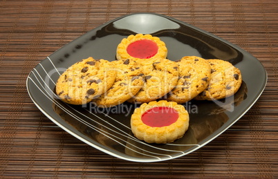 plate of cookies on dark brown background