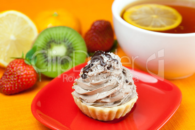 lemon tea ,lemon,mandarin.kiwi,cake and strawberries lying on th