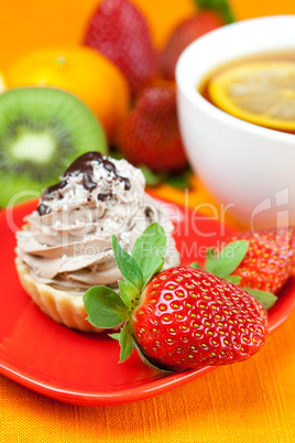 lemon tea ,lemon,mandarin.kiwi,cake and strawberries lying on th