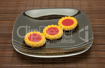 plate of cookies on dark brown background