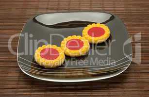 plate of cookies on dark brown background