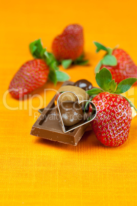chocolate bars, strawberry, heart and the candy on the orange fa