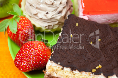 cake and strawberries lying on the orange fabric