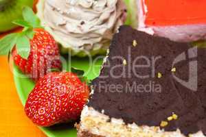 cake and strawberries lying on the orange fabric