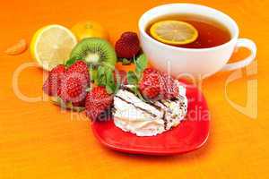lemon tea,lemon, mandarin, kiwi,cake and strawberries lying on t