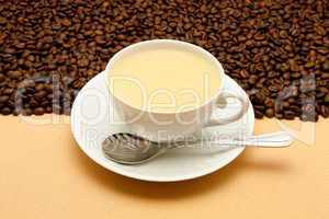 White cup of coffee and coffee beans