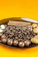 plate of coffee beans, cinnamon  and the sweets