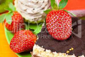 cake and strawberries lying on the orange fabric