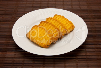 plate of cookies on dark brown background