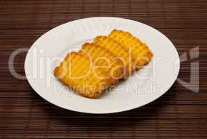 plate of cookies on dark brown background