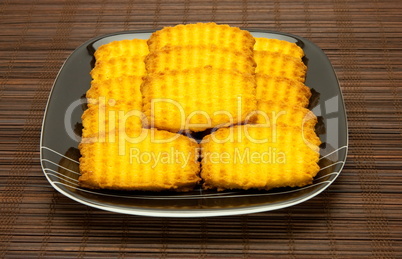 plate of cookies on dark brown background