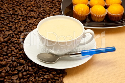 White cup of coffee and coffee beans