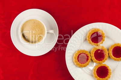 Coffee and cookies on a red background