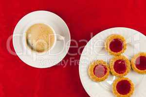 Coffee and cookies on a red background