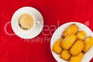 Coffee and cookies on a red background