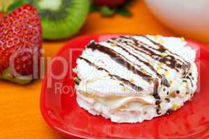 lemon tea, kiwi,cake and strawberries lying on the orange fabric