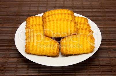 plate of cookies on dark brown background