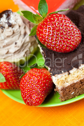 cake and strawberries lying on the orange fabric