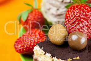 cake, chocolates and the strawberries on the orange fabric