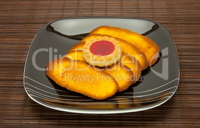 plate of cookies on dark brown background