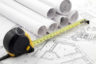rolls of architectural house plans & tape measure