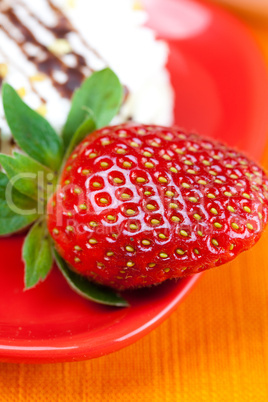 cake and strawberries lying on the orange fabric