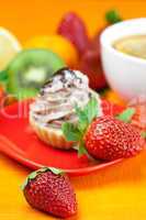 lemon tea ,lemon,mandarin.kiwi,cake and strawberries lying on th