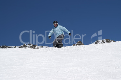 Snowboarder descends a slope