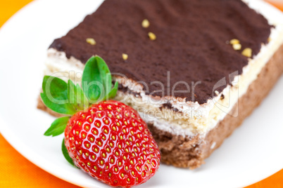 cake and strawberries lying on the orange fabric