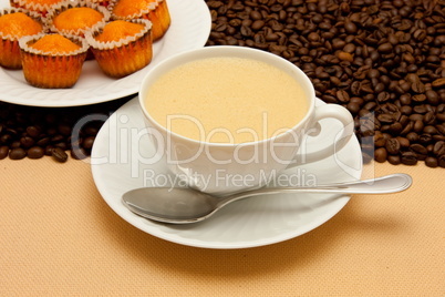 White cup of coffee and coffee beans