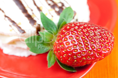 cake and strawberries lying on the orange fabric