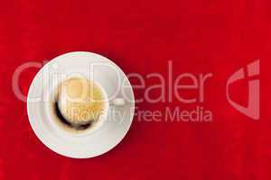 white cup of coffee  on red background