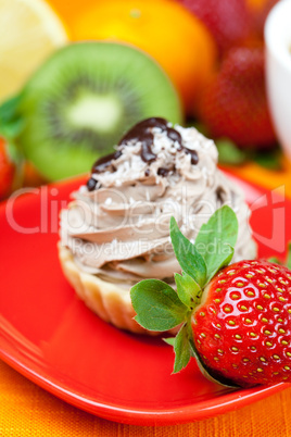 lemon,mandarin,kiwi,cake and strawberries lying on the orange fa