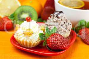 lemon,lemon tea,mandarin,kiwi,cake and strawberries lying on the