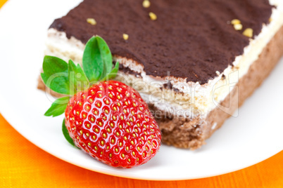 cake and strawberries lying on the orange fabric