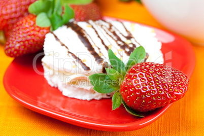 cake and strawberries lying on the orange fabric