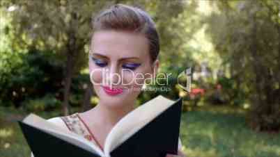 Portrait of nice young smiling woman with book