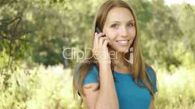 Young smiling woman call by mobile phone.