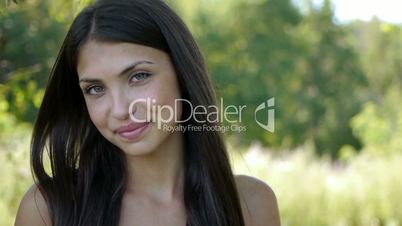 Portrait of young cheerful attractive smiling woman eating red ripe cherry