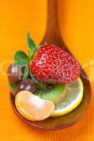 Strawberries, kiwi, mandarin orange, lemon and chocolate candy i