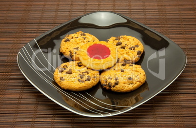 plate of cookies on dark brown background