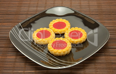 plate of cookies on dark brown background