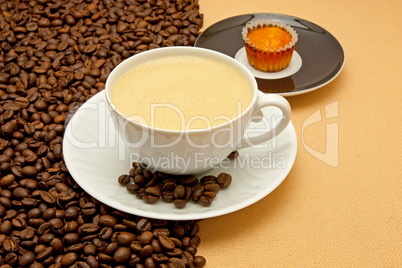 White cup of coffee and coffee beans