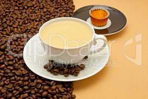 White cup of coffee and coffee beans