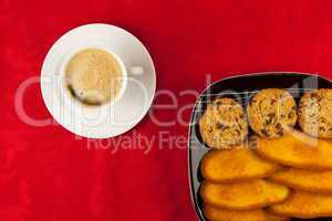 Coffee and cookies on a red background